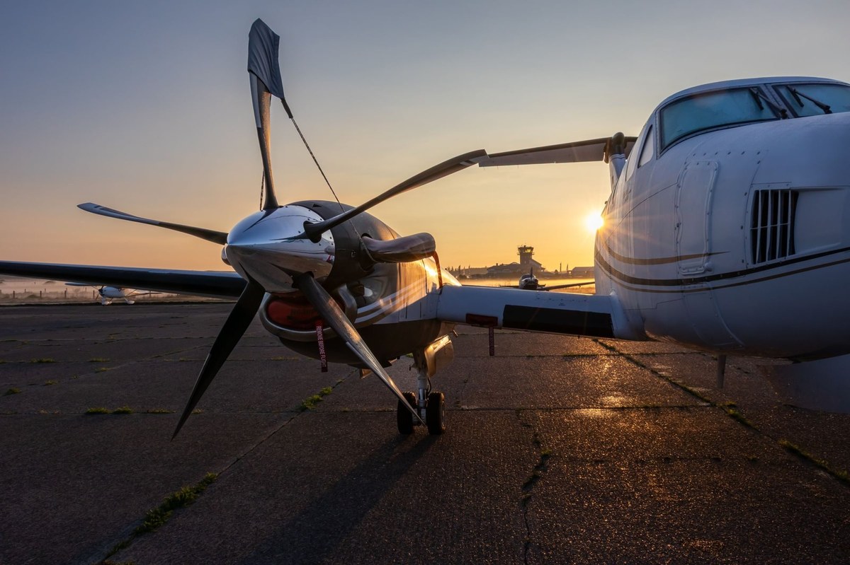 A private aircraft on a runway at sunrise.