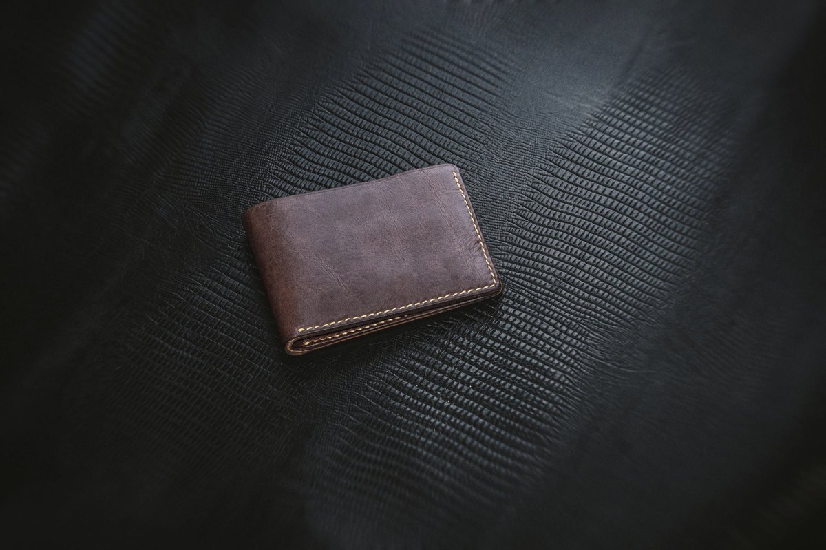 A brown leather bifold wallet.