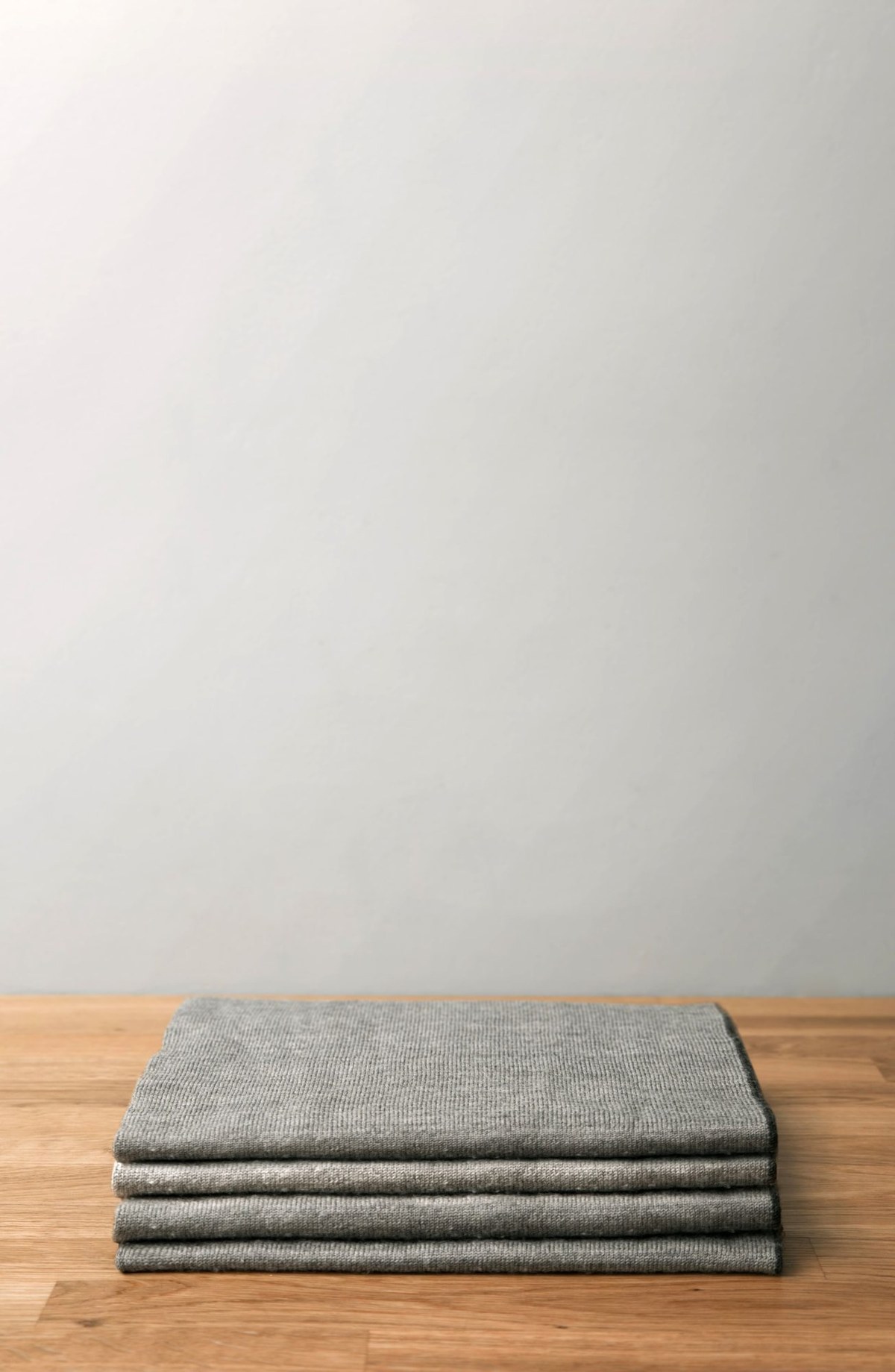 Folded gray wool blankets.